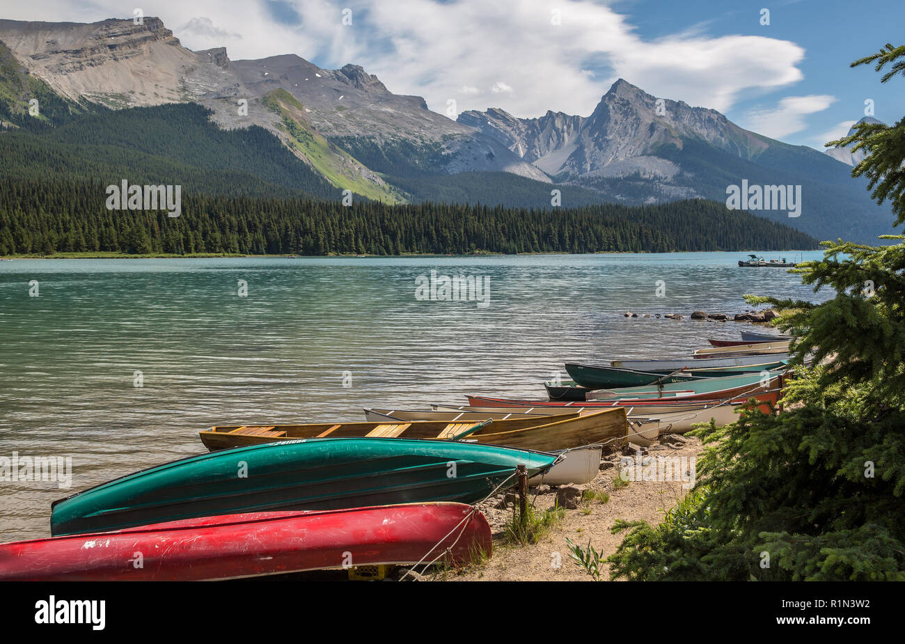 Canoes and other watercraft along the shore of Maligne Lake in Jasper National Park, Alberta Canada Stock Photo