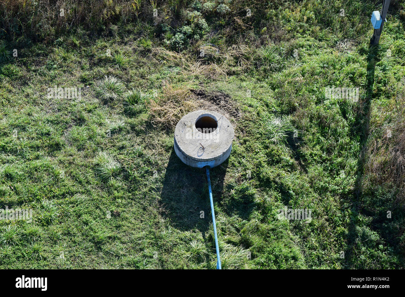 Well of an artesian well with a submersible pump. Covered with a