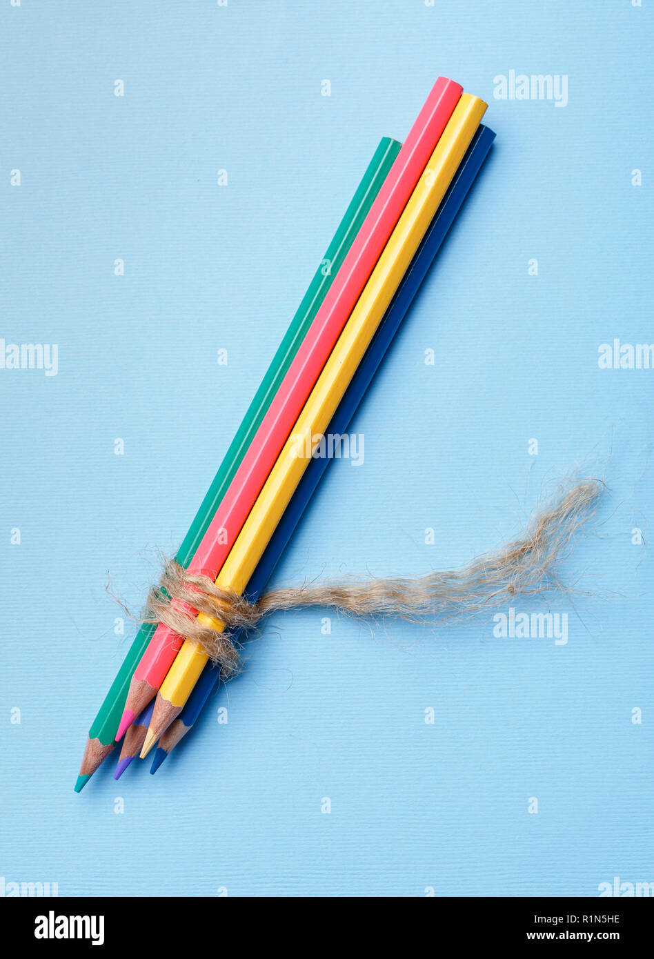 The group of pencils is connected by a rope Stock Photo - Alamy