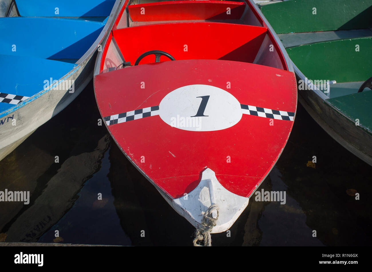 Bright red pleasure boat for hire by the Thames at Henley-on-Thames, Oxfordshire Stock Photo