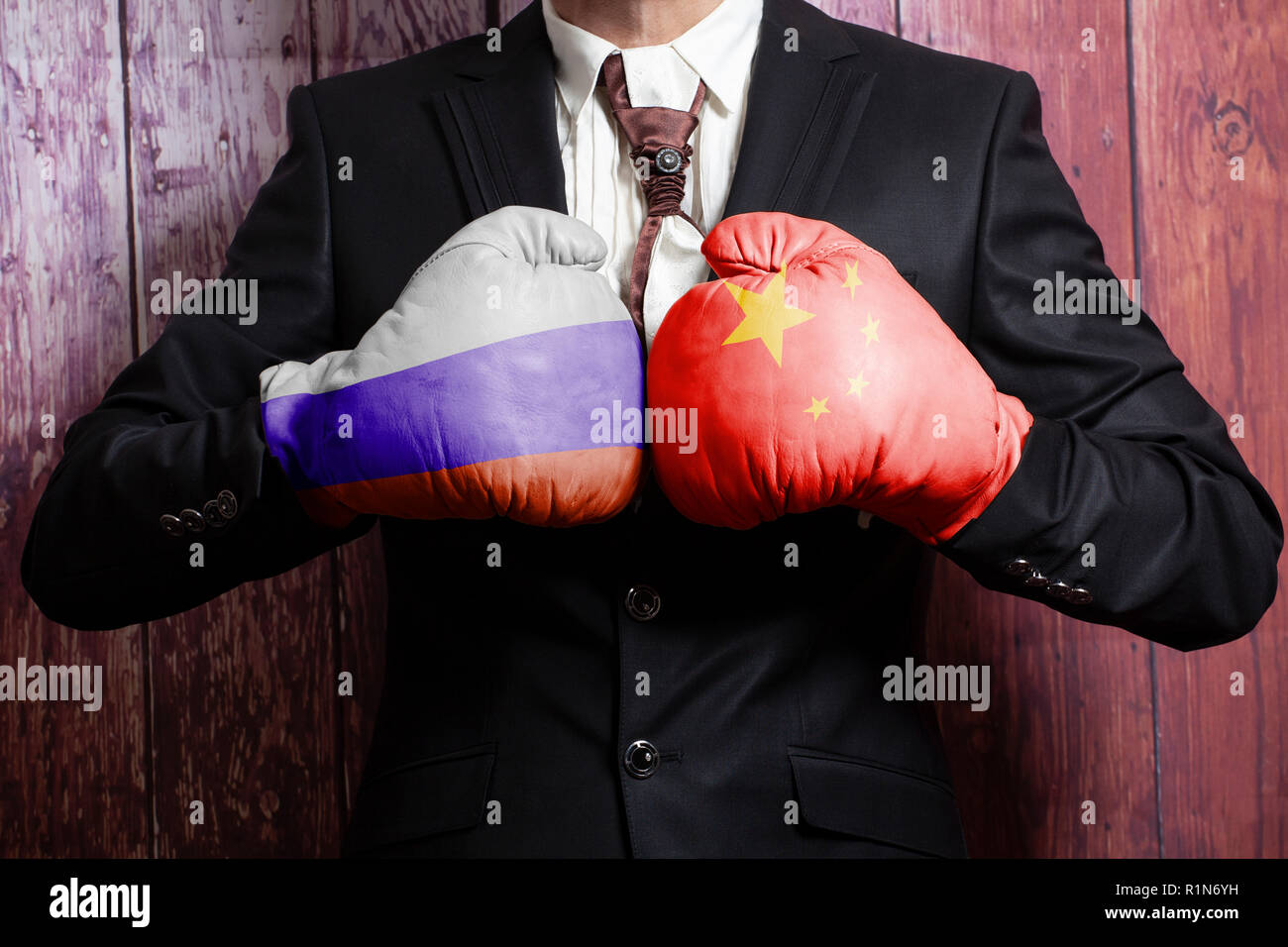 Businessman in boxing gloves with Russian and China flag. Russia versus  China concept Stock Photo - Alamy