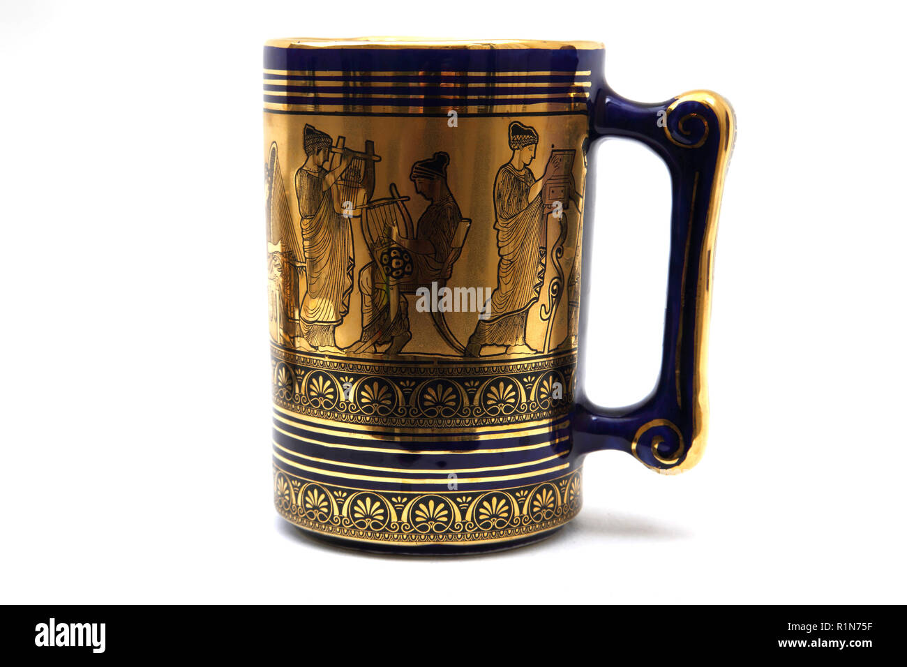 Greek Ceramic Cobalt Blue Tankard with 24K Gold Hand Painted Design of Musicians Stock Photo