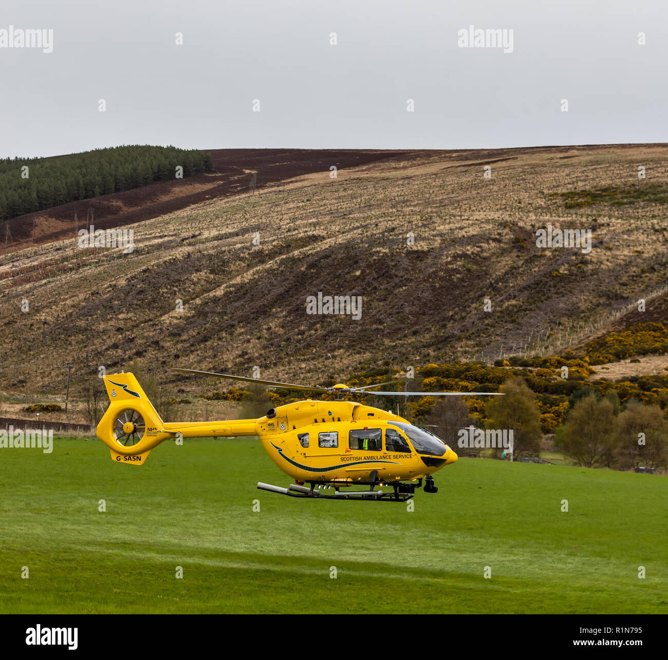SCOTTISH AIR AMBULANCE - This is the Inverness based Scottish Air Ambulance taking off with a patient on Rothes Glen, Moray, Scotland. Stock Photo