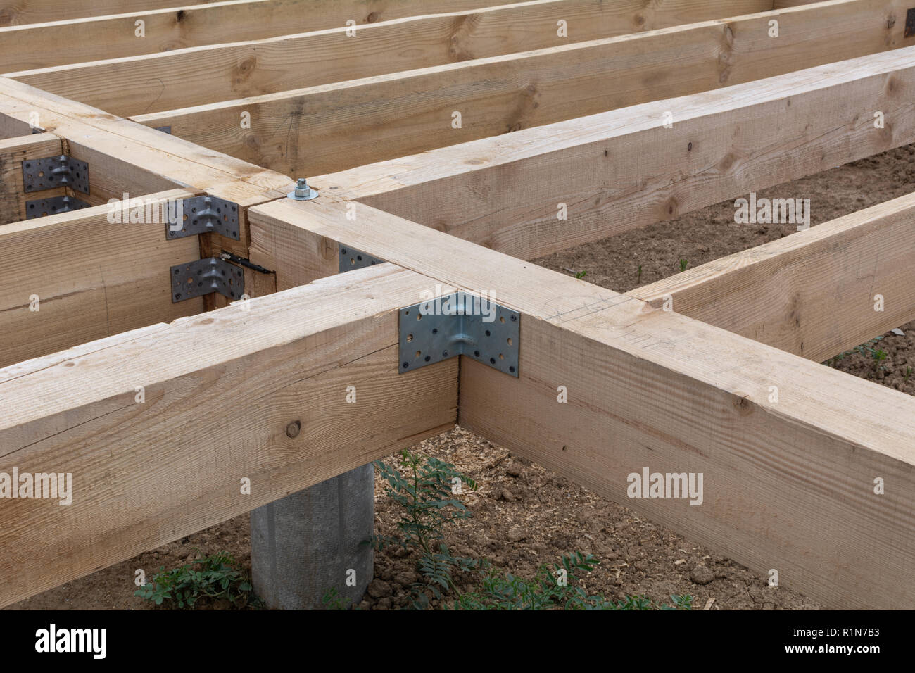 Housing frame assembly. Installation of residential building base of a-type frame house. Stock Photo
