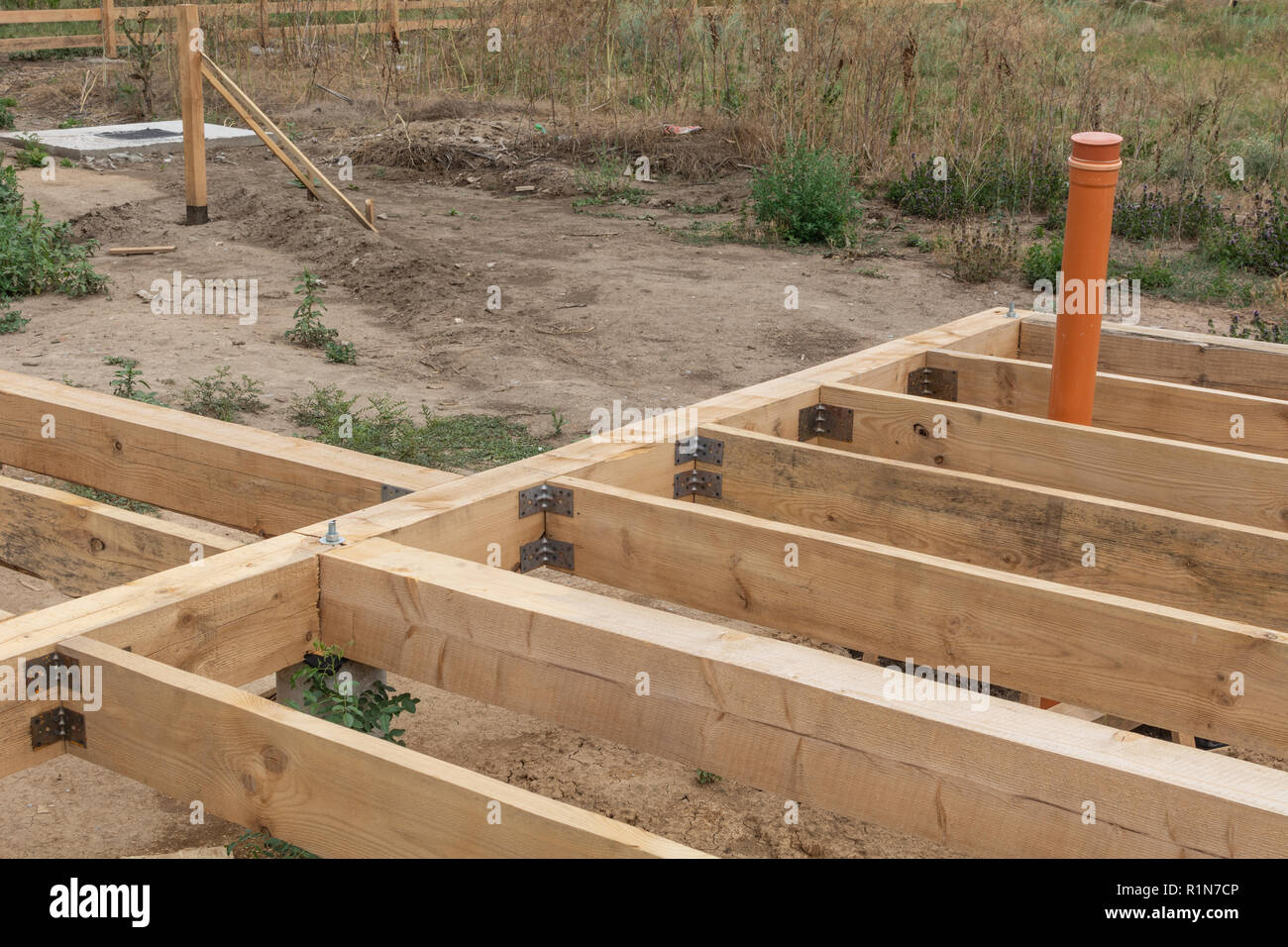 Housing frame assembly. Installation of residential building base of a-type frame house. Stock Photo