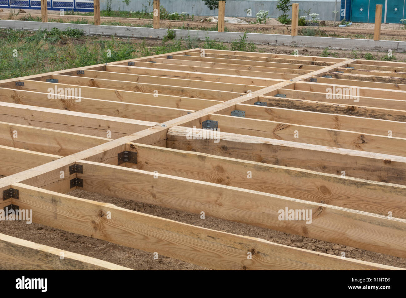 Housing frame assembly. Installation of residential building base of a-type frame house. Stock Photo