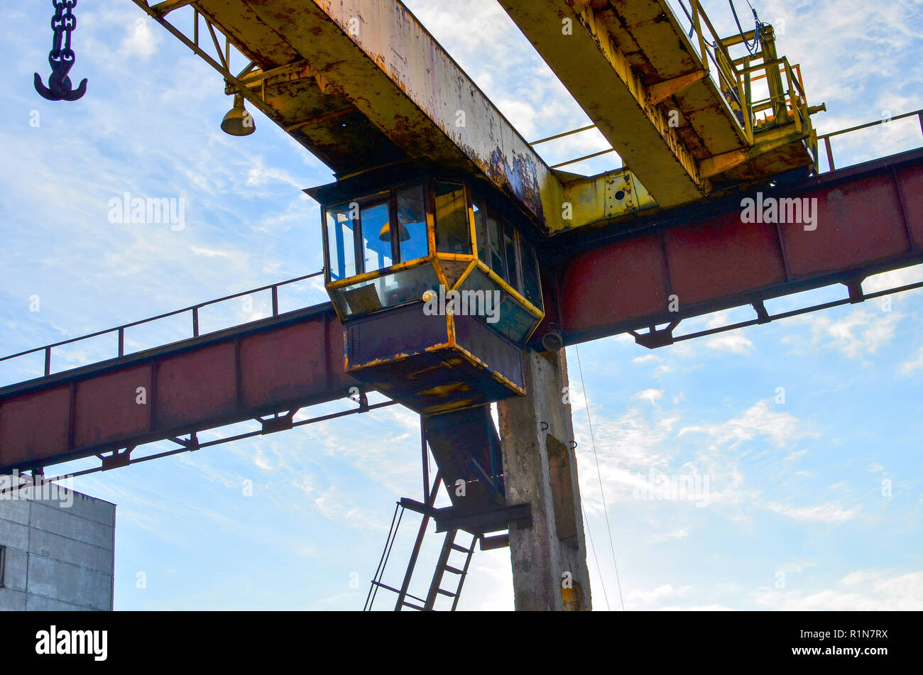 Cabin gantry crane with a hook on the chain. Gantry crane hook