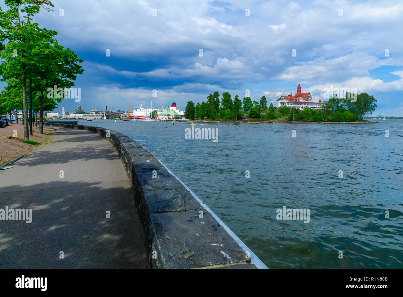 View of the Luoto island, with the promenade, ferry boats, the Russian Orthodox Uspenski Cathedral, and the SkyWheel in Helsinki, Finland Stock Photo