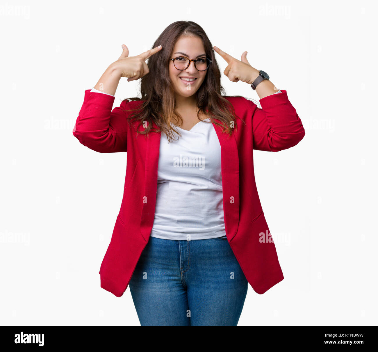 Beautiful plus size young business woman wearing elegant jacket and glasses over isolated background Smiling pointing to head with both hands finger,  Stock Photo