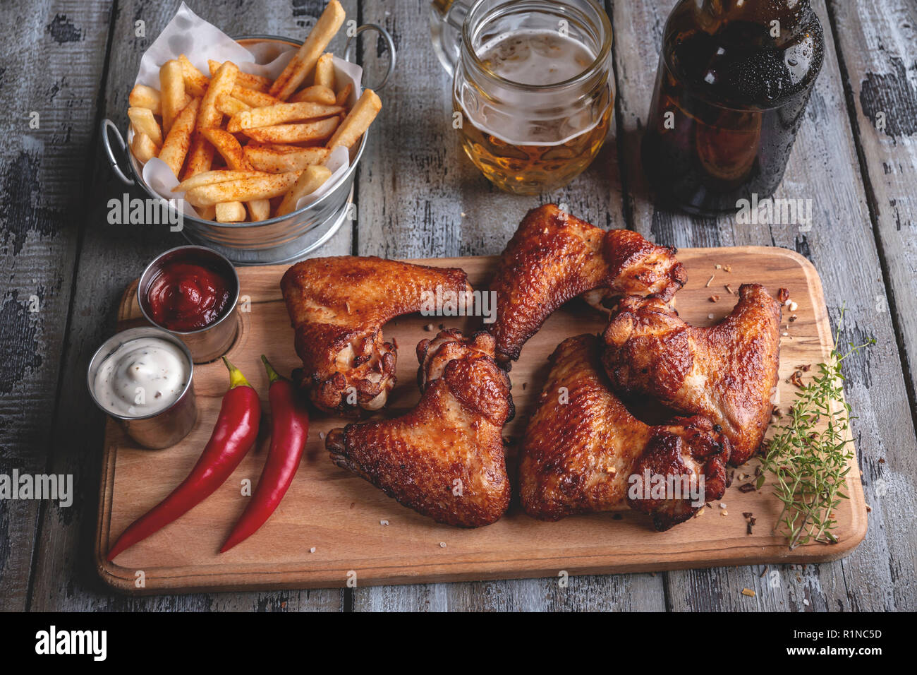 Fried chicken wings, french fries, white and red sauce. Beer snack Stock Photo