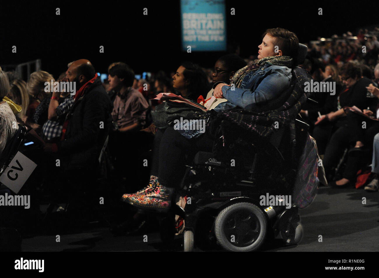 Liverpool, England. 23rd September, 2018.  Young woman delegate, sitting in a wheelchair, listening to debate on the Labour Party Democracy Review, at Stock Photo