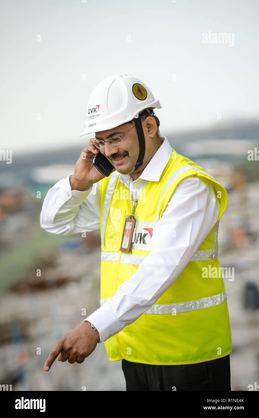 Safety officers pointing while talking over the phone. Stock Photo