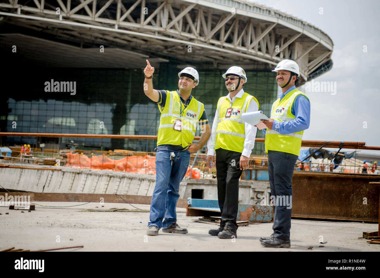 Safety officers pointing at the construction site at Mumbai International Airport. Stock Photo