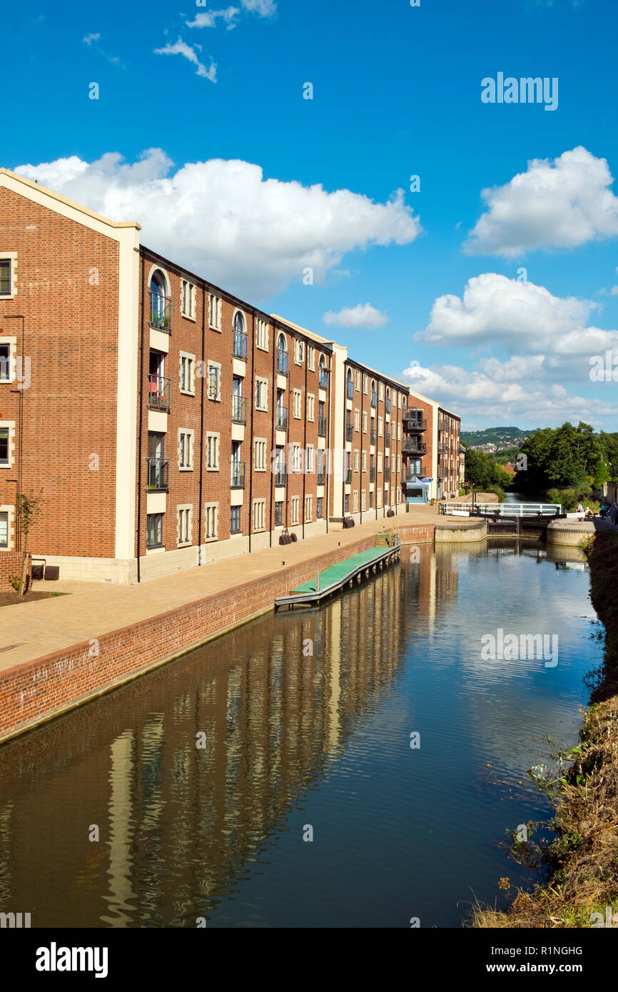 Stroud, Gloucestershire, UK - 26th August 2016: Summer sunshine brings people out to enjoy the regenerated Stroudwater Canal project at Ebley, Stroud, Gloucestershire, UK.  Recently built apartment buildings enhance the waterside around historic Ebley Mill. Stock Photo