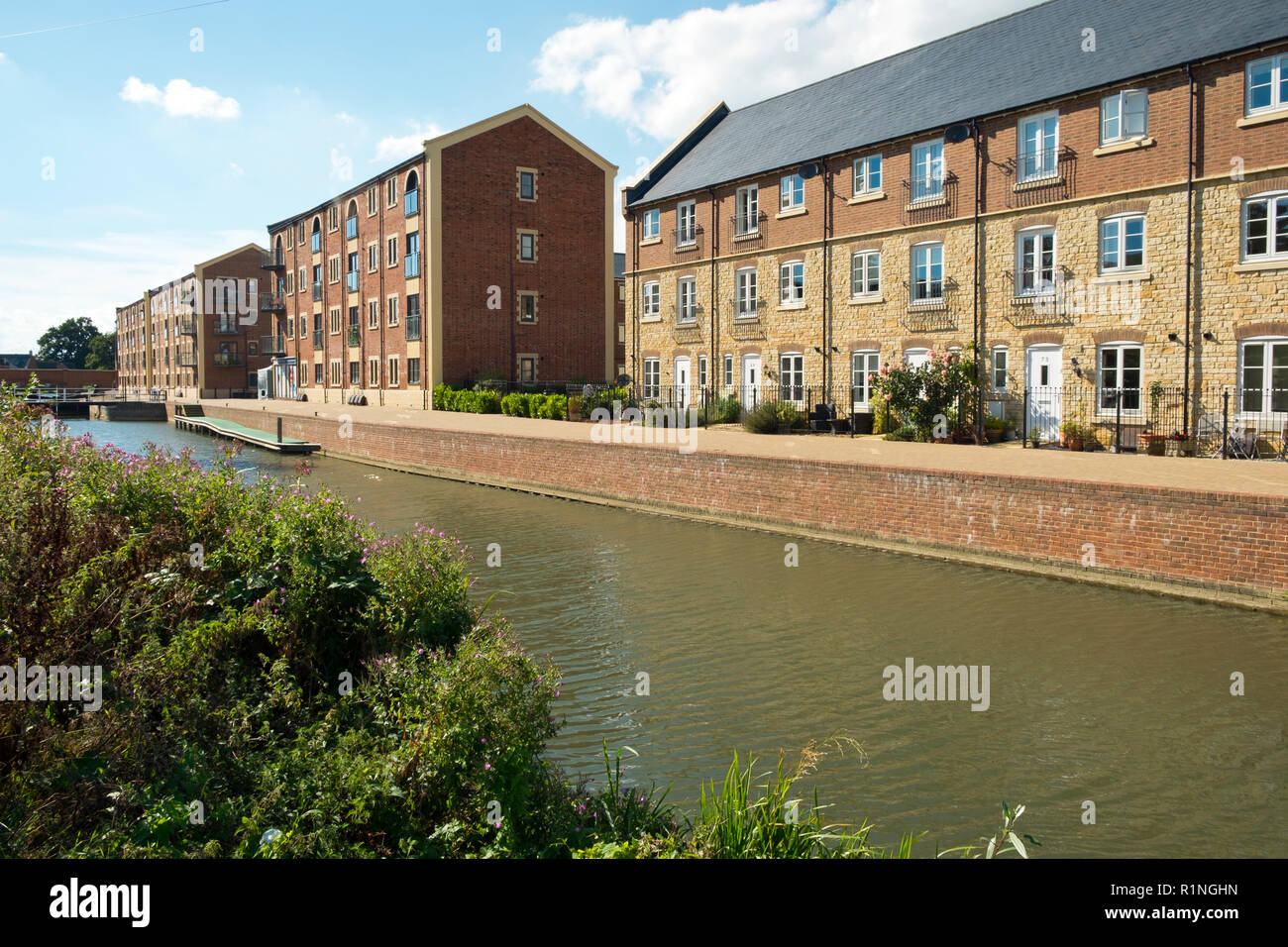 Stroud, Gloucestershire, UK - 26th August 2016: Summer sunshine brings people out to enjoy the regenerated Stroudwater Canal project at Ebley, Stroud, Gloucestershire, UK. Recently built housing enhances the waterside near historic Ebley Mill. Stock Photo