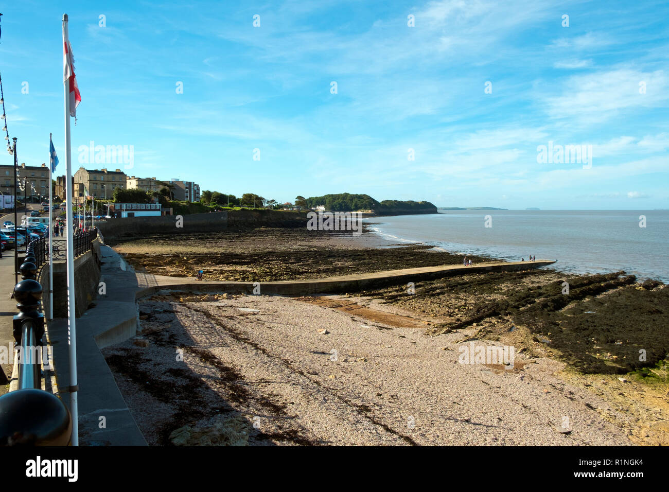 Clevedon, Somerset, UK - 11th September 2016: Late summer sunshine brings visitors to the rocky shore and seafront at Clevedon on the Bristol Channel, Somerset, UK. Clevedon in the Victorian era was a popular seaside resort. Stock Photo