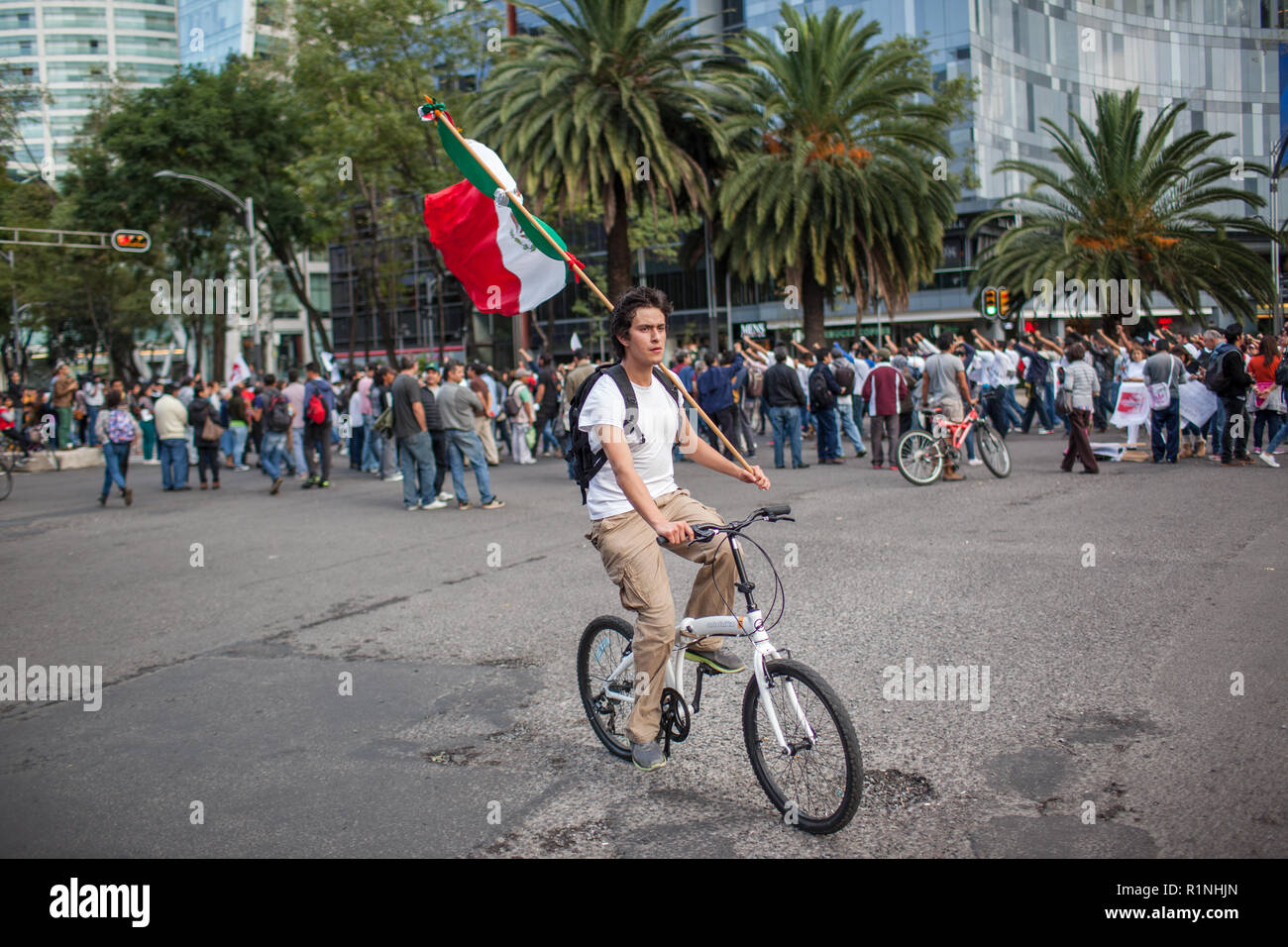 People march through Mexico City during the 'Global Day of Action for Ayotzinapa' Wednesday, October 23, 2014.  The march was held to demand answers following the killing of three students and the disappearance of 43 more in the city of  Ayotzinapa, Guerrero, which is South West of Mexico City.  The students have been missing since September 26, 2014 and the local mayor and his wife are accused of ordering the kidnappings and killings. The local police are also accused of working with  the Guerreros Unidos cartel in the crimes.   Since September 26, many mass graves have been located in the ar Stock Photo