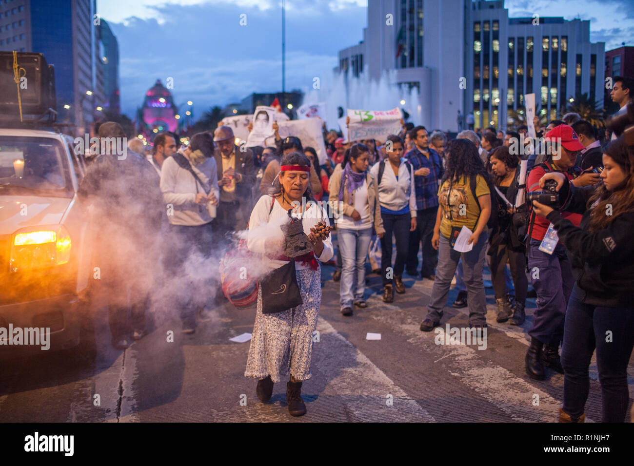 People march through Mexico City during the 'Global Day of Action for Ayotzinapa' Wednesday, October 23, 2014.  The march was held to demand answers following the killing of three students and the disappearance of 43 more in the city of  Ayotzinapa, Guerrero, which is South West of Mexico City.  The students have been missing since September 26, 2014 and the local mayor and his wife are accused of ordering the kidnappings and killings. The local police are also accused of working with  the Guerreros Unidos cartel in the crimes.   Since September 26, many mass graves have been located in the ar Stock Photo