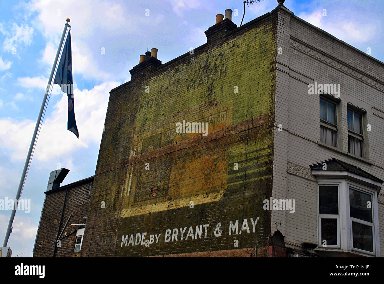 A Ghostsign for Bryant & May the smokers match, a 1950s painted advert that survived till 2015 when it was covered by building works. Stock Photo