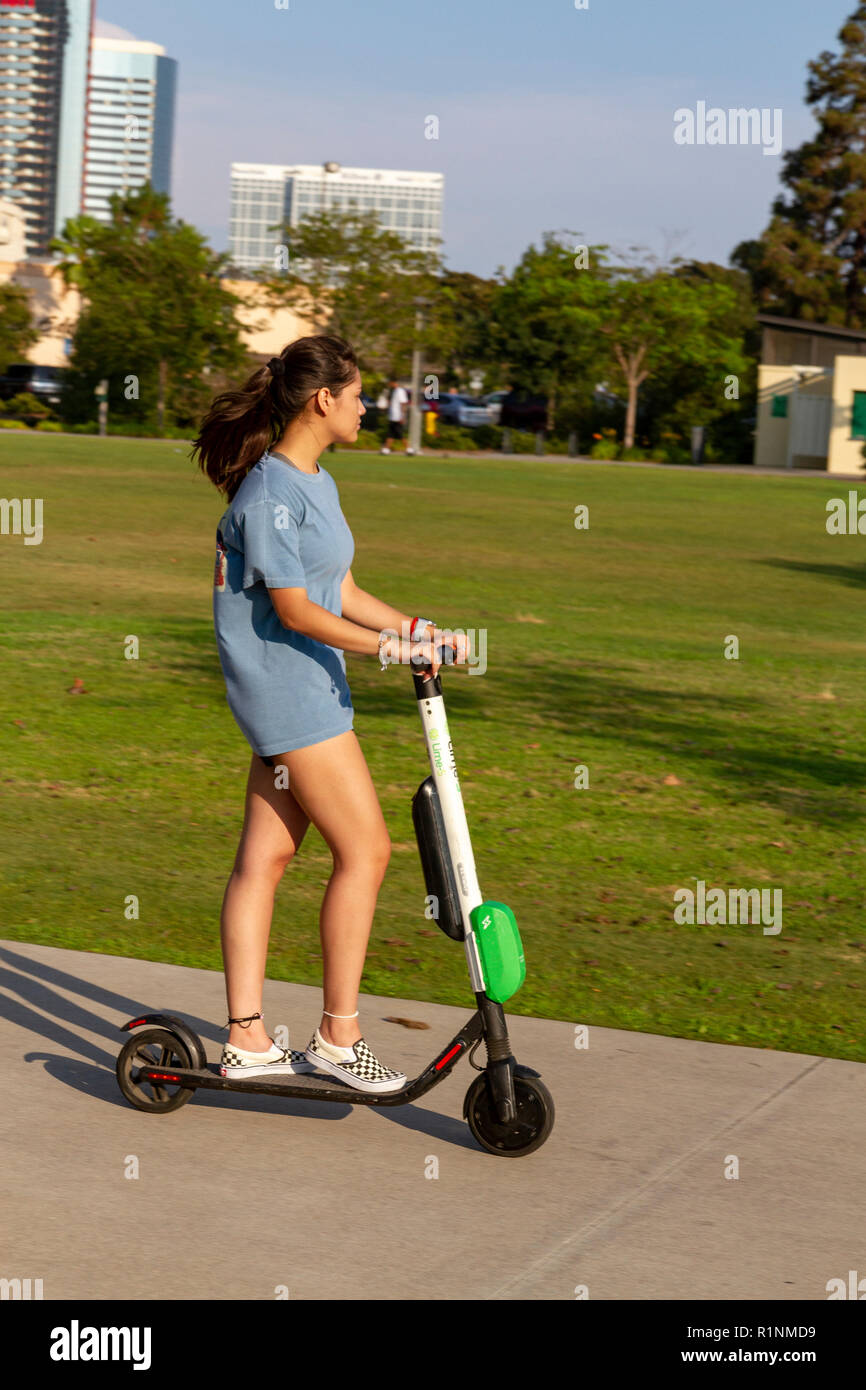 Woman on a 'Lime' electric scooters riding on a footpath in San Diego,  California, United States Stock Photo - Alamy
