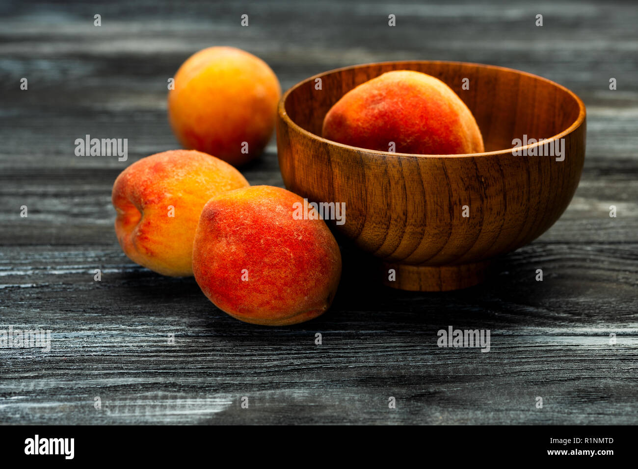 fresh peaches in a plate with leaves Stock Photo