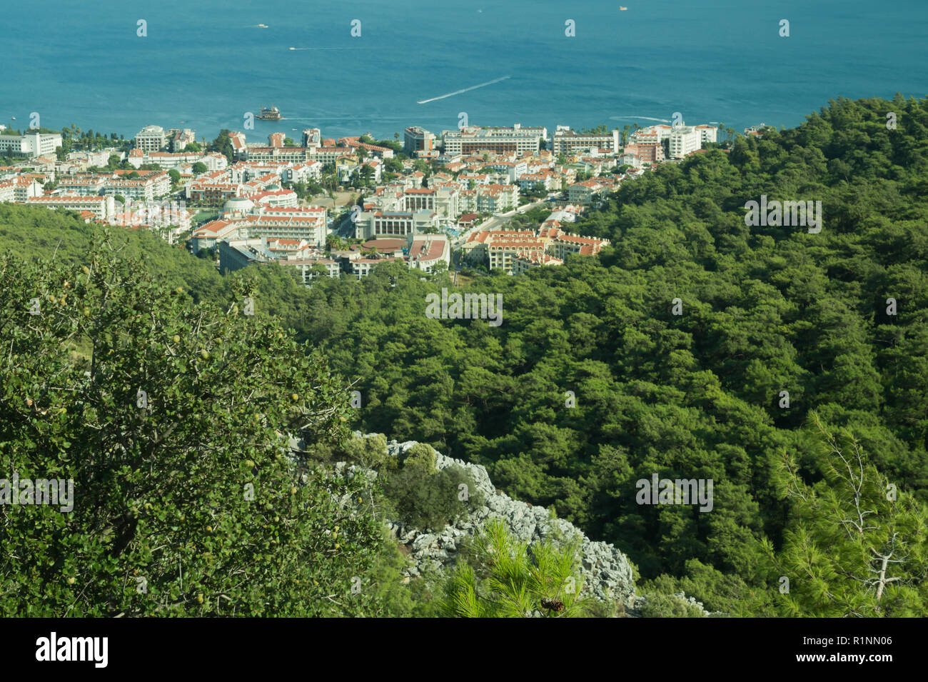 Nature landscape with a city by the shore of the sea between the hills ...