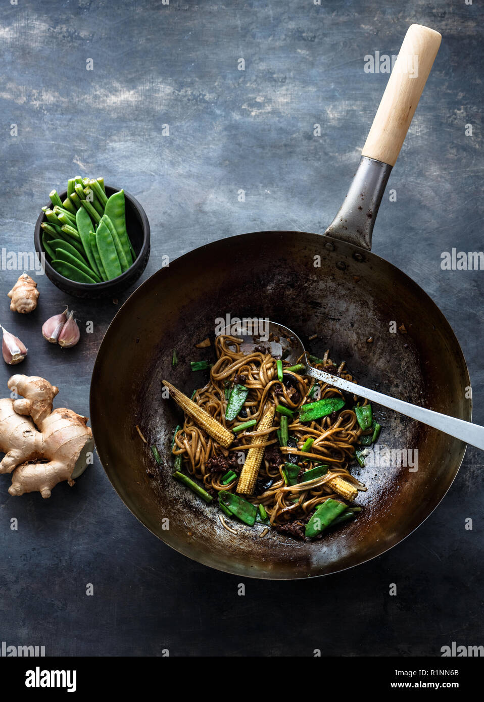 Beef, vegetables and noodles stir-fry in a wok, copy space Stock Photo