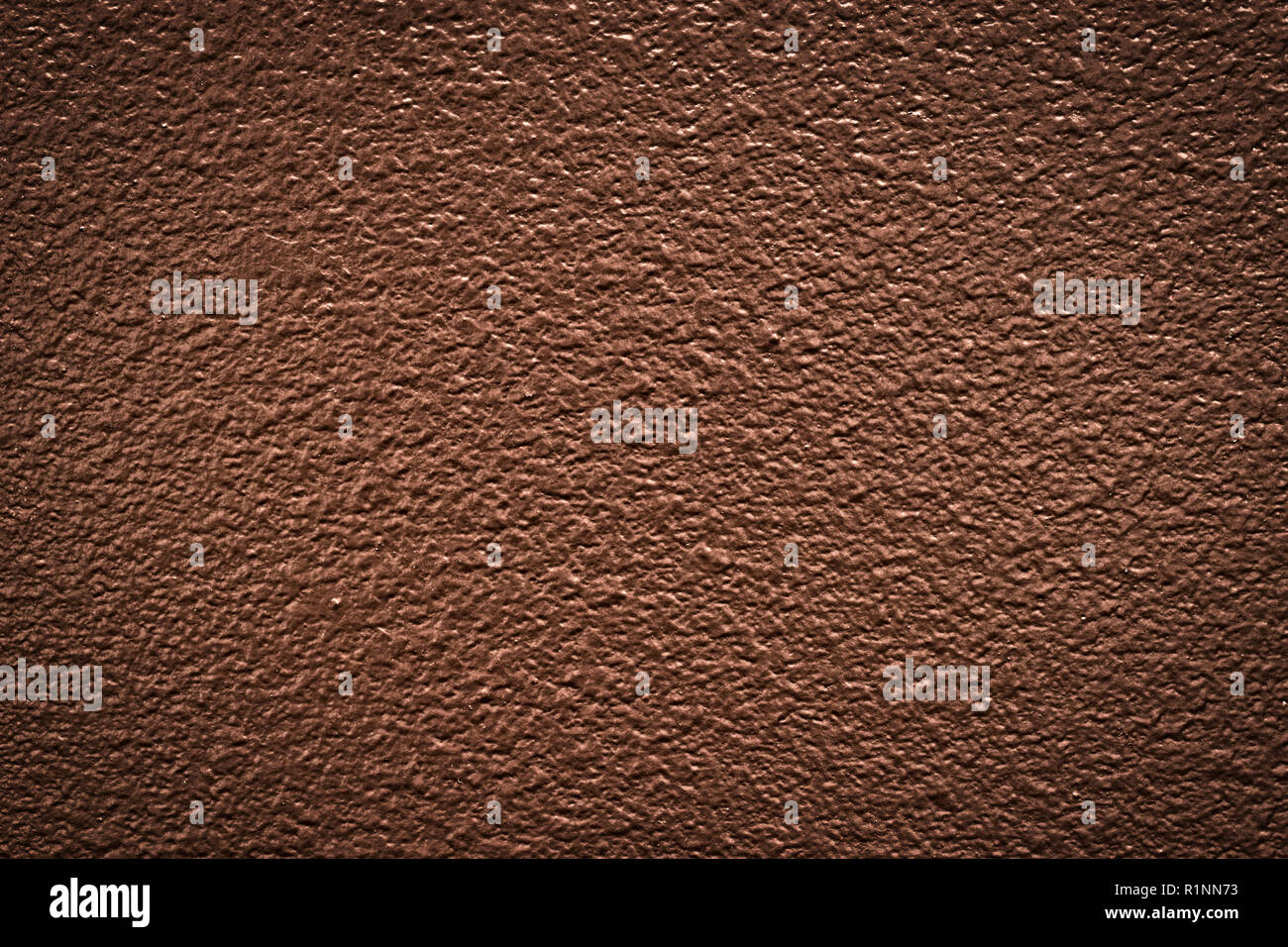 Textured brown wall paint from a house interior with a dramatic look