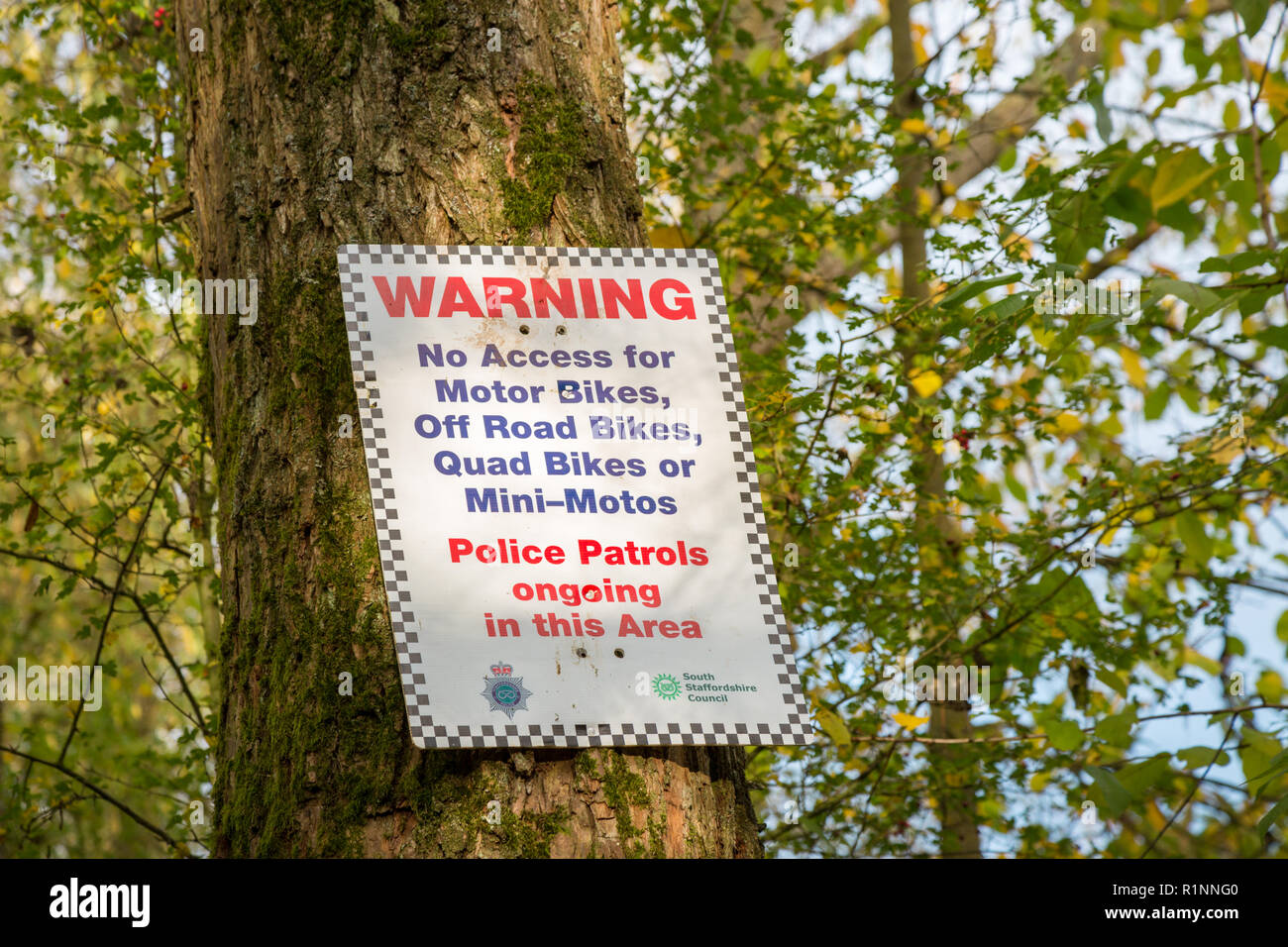Warning sign nailed to a tree, no access for bikes, off road, quad or mini motos, UK Stock Photo