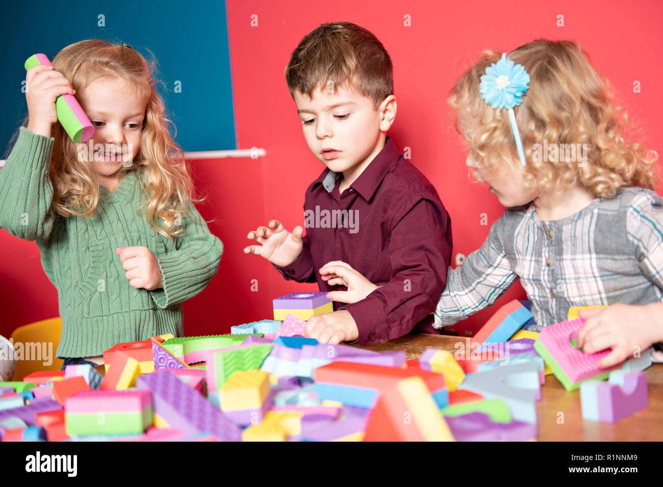The preschoolers group in kindergarten together, Nursery group play with block , Stock Photo