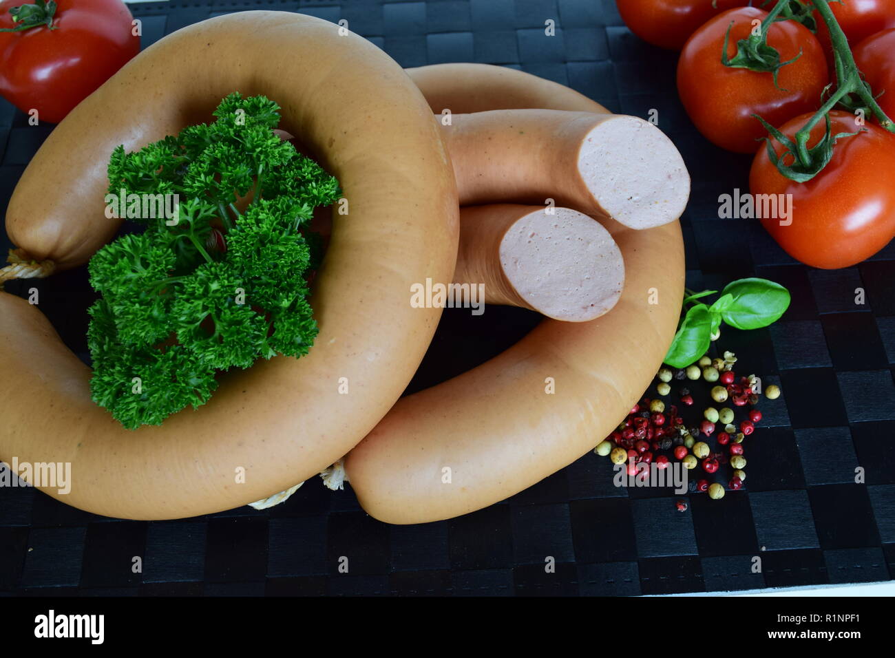 Lyoner is a Sausage delicatessen on a black placemat. Lyoner ist ein