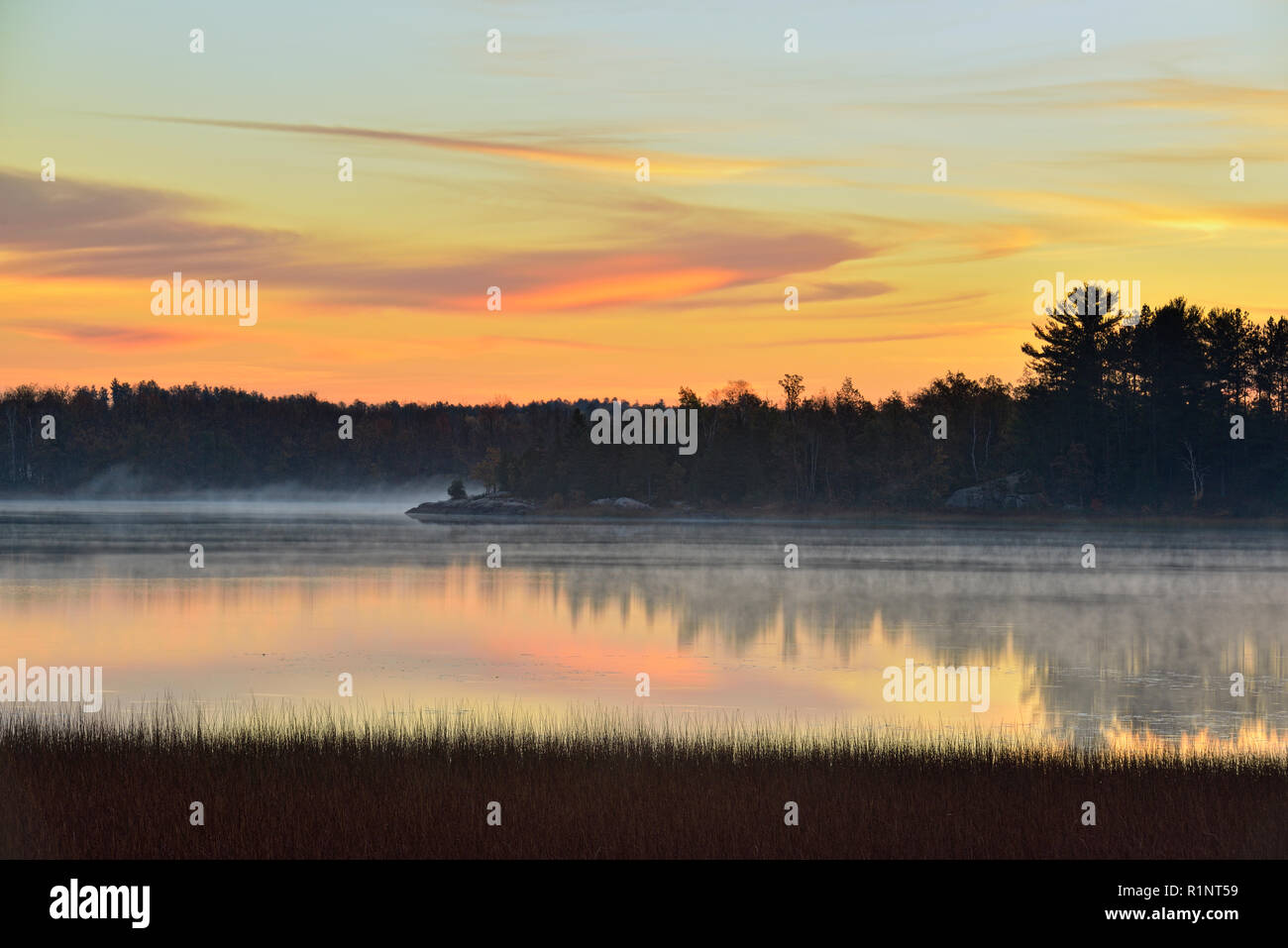 Dawn skies reflected in the Vermilion River, Whitefish Lake First