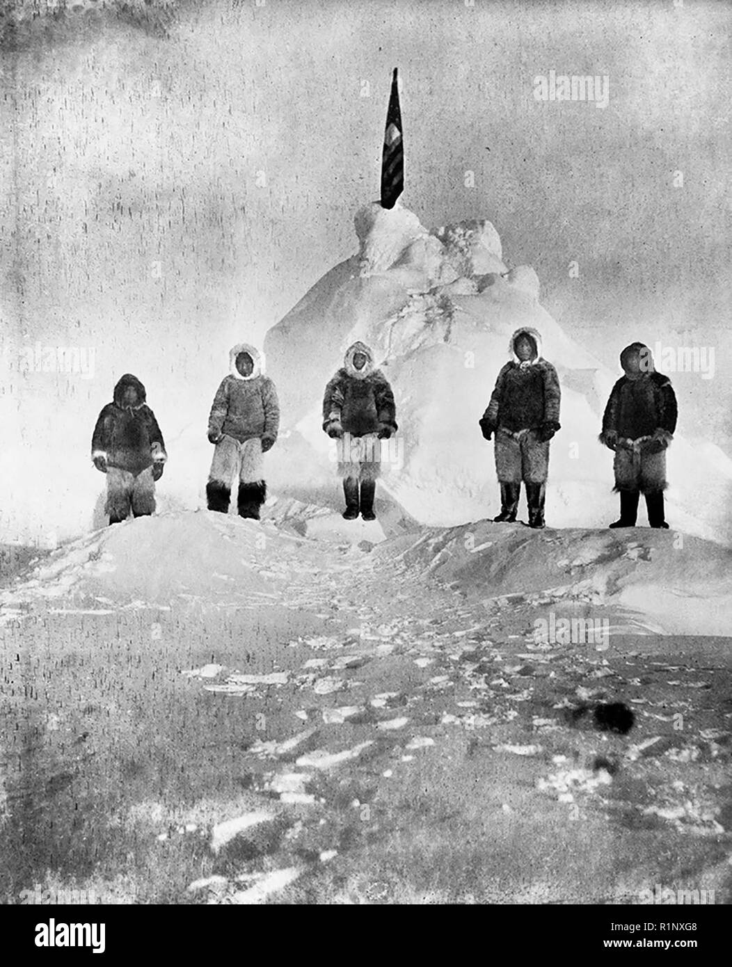 Matthew Henson (center) and four Inuit guides (Ooqeah, Ootah, Egingwah, and Seeglo). Circa 1908 Stock Photo