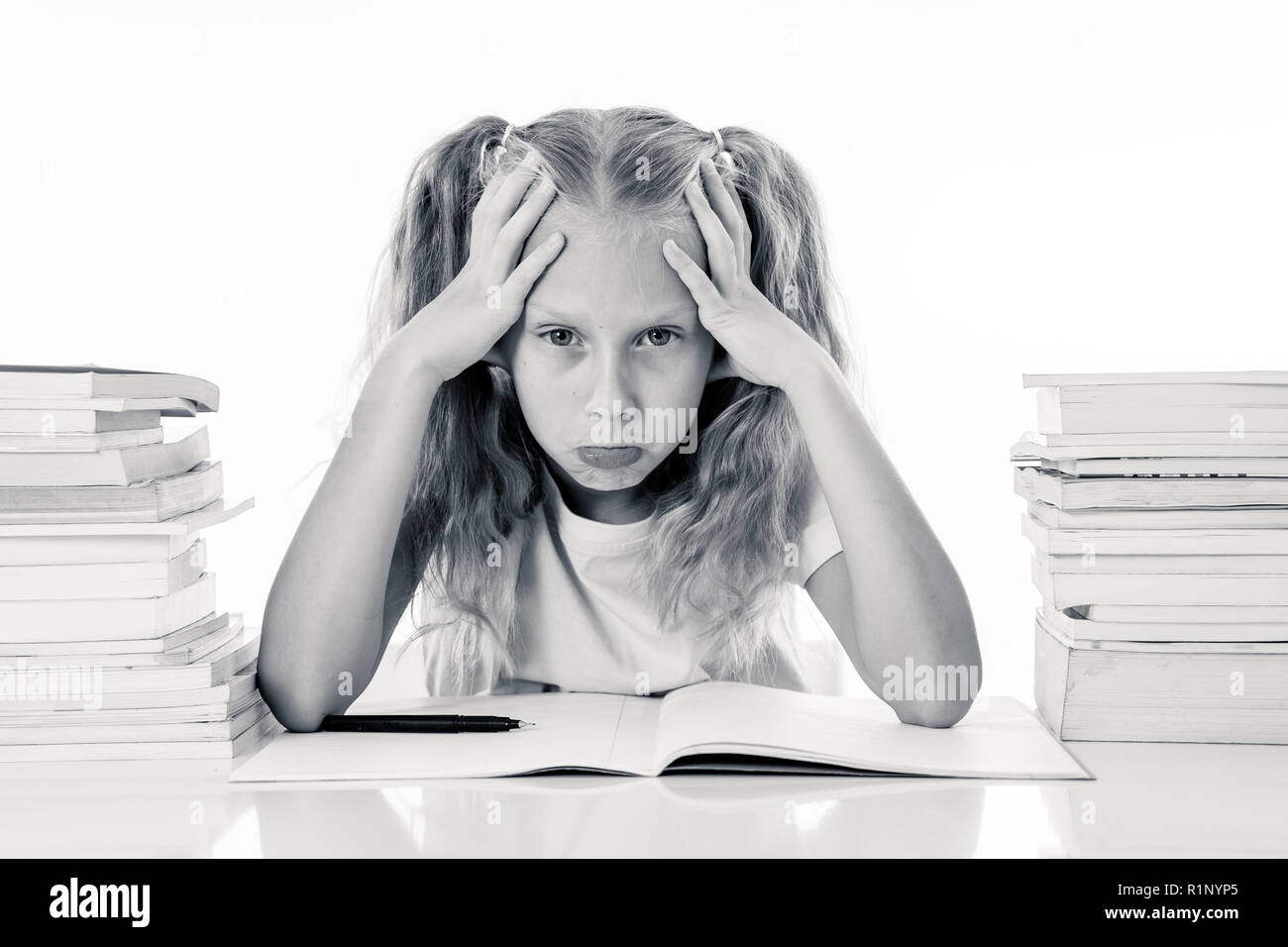 Frustrated little schoolgirl feeling a failure unable to concentrate in