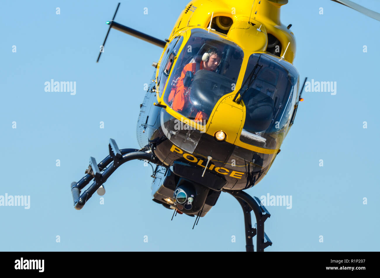 Police helicopter with pilot. Eurocopter EC135 helicopter. Law enforcement aviation. Flying with space for copy Stock Photo