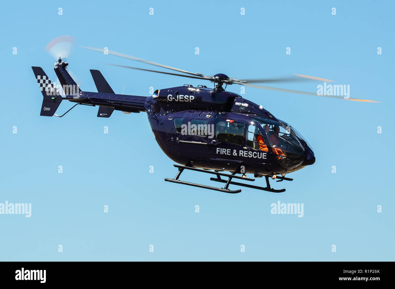 Eurocopter EC145 MBB BK117 G-JESP Fire and Rescue helicopter. Emergency response helicopter. Flying. Space for copy Stock Photo