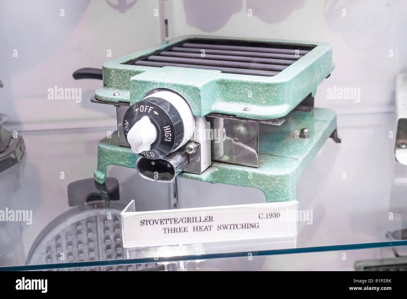 A 1930's Electric Griller with 3 heat settings finished in speckled green enamel on display at Tamworth Australia Power Station Museum. Stock Photo