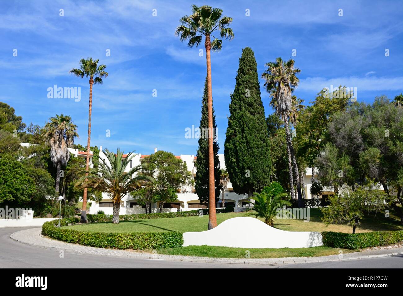 Entrance to a tourist apartment block complex with palm trees in the