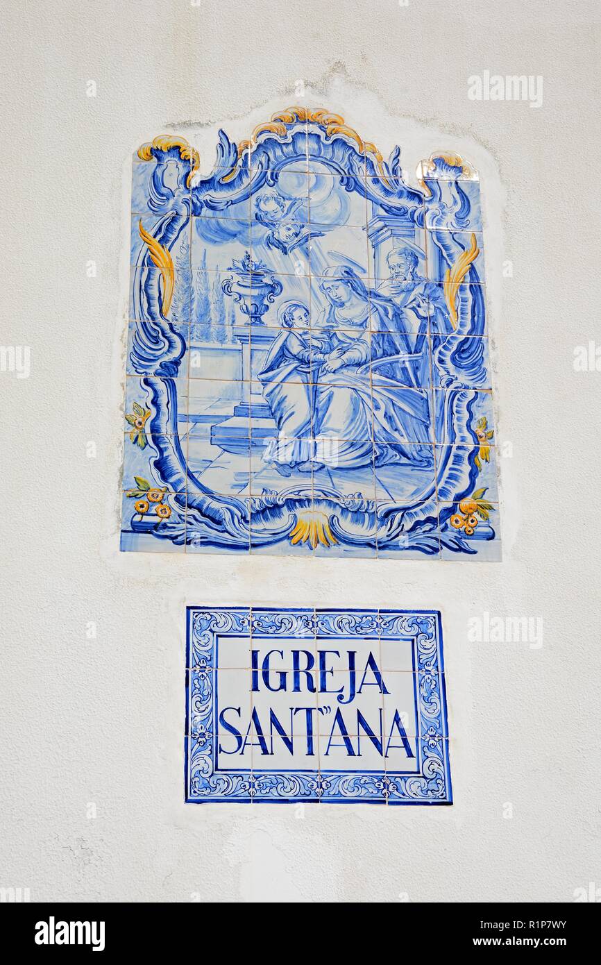 Traditional Portuguese blue and gold ceramic religious picture on the wall of St Annes church (Igreja de Sant'Ana), Albufeira, Algarve, Portugal, Euro Stock Photo