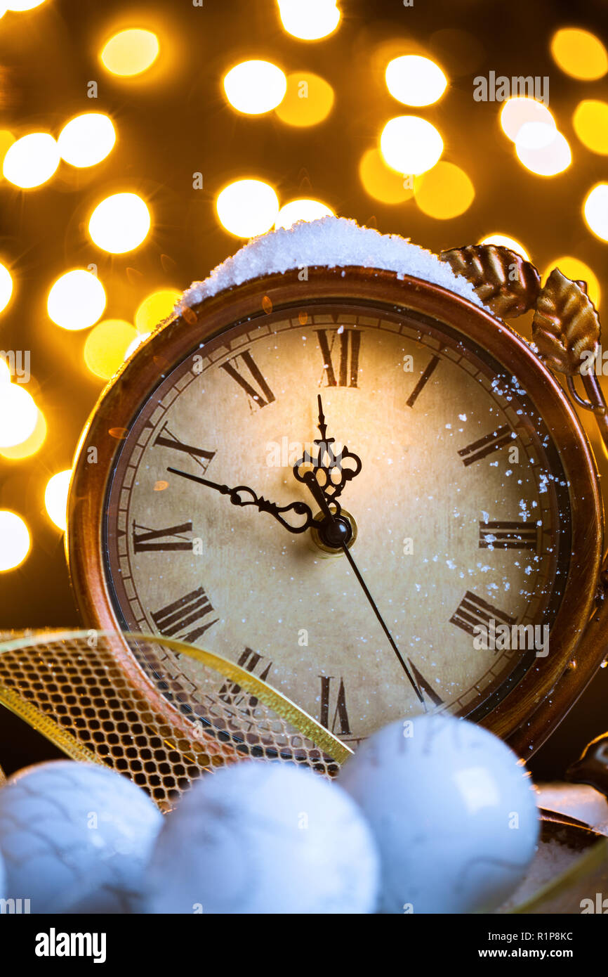 New Years clock and white balls covered with lights Stock Photo