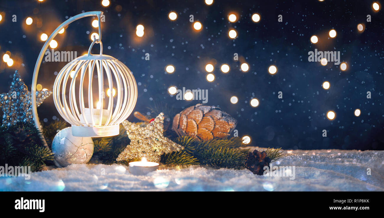Christmas Lantern On Snow With Fir Branch In Evening Scene Stock Photo