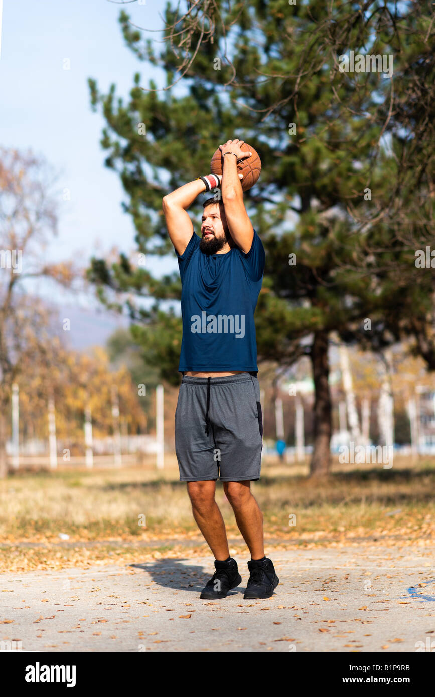 Man playing basketball in the park close up Stock Photo