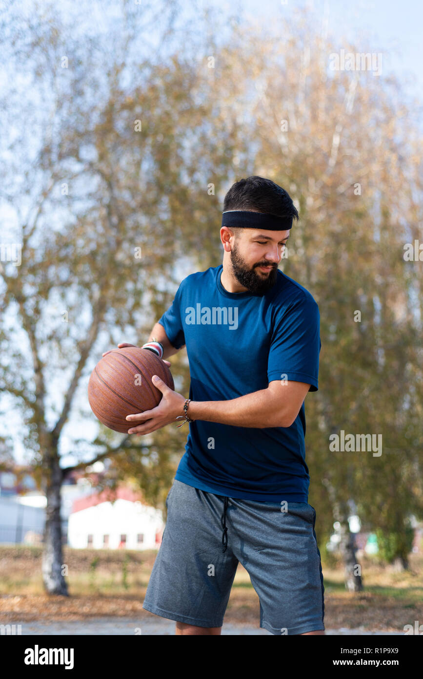 Man playing basketball in the park close up Stock Photo