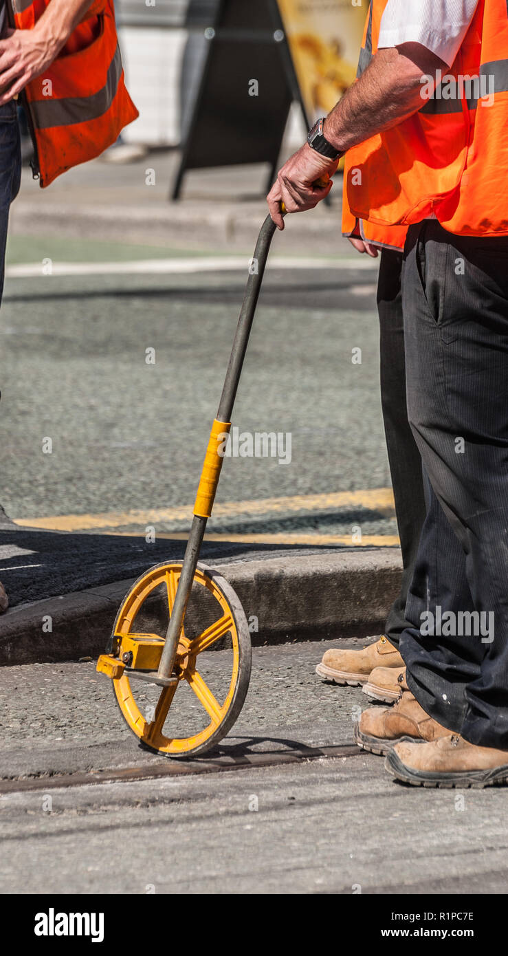 Surveyors With Measuring Wheel Stock Photo