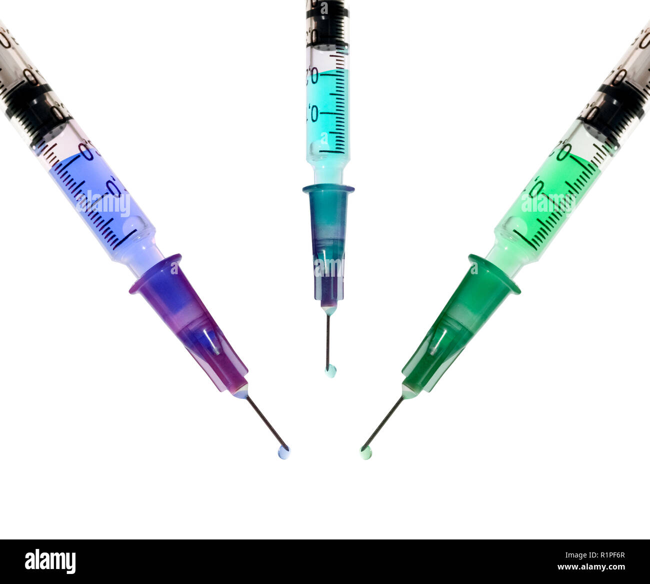 Three Hypodermic Syringes filled with colourful liquid as a vaccination