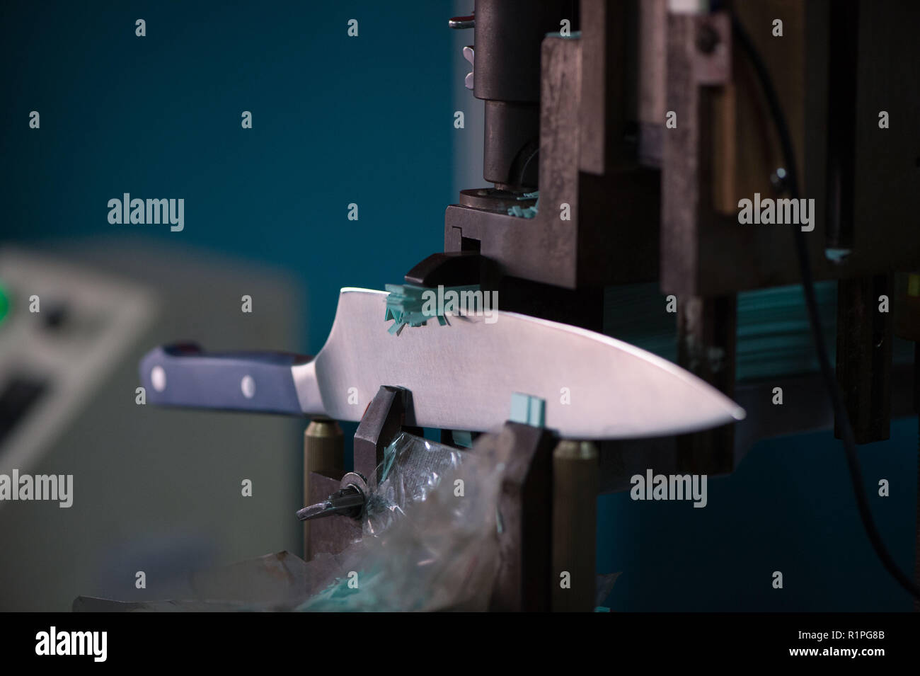 Knife blade making test cut with paper on machinery, manufacturing Stock Photo Alamy