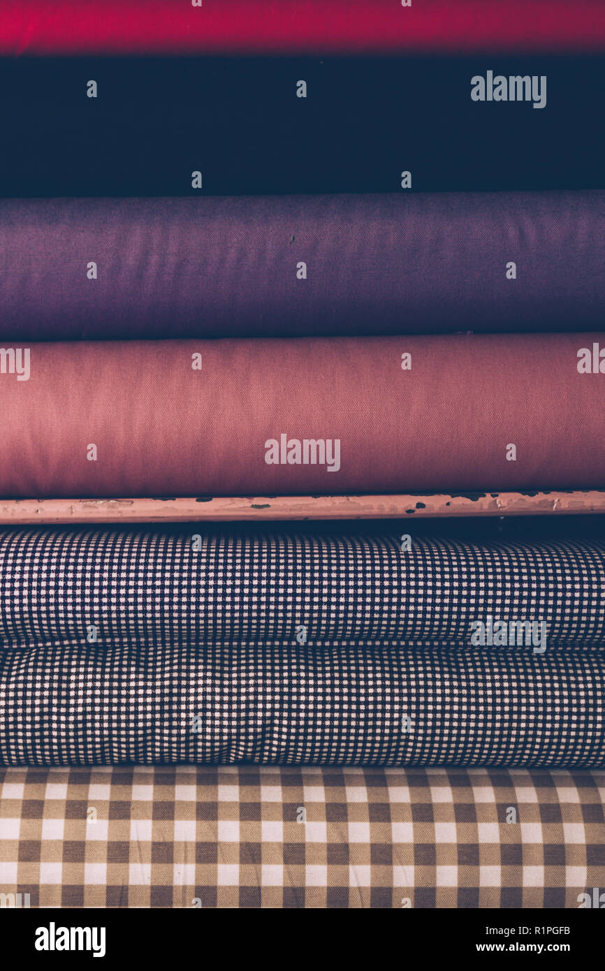Satin drapery fabric rolls in a fabric shop shelf Stock Photo Alamy