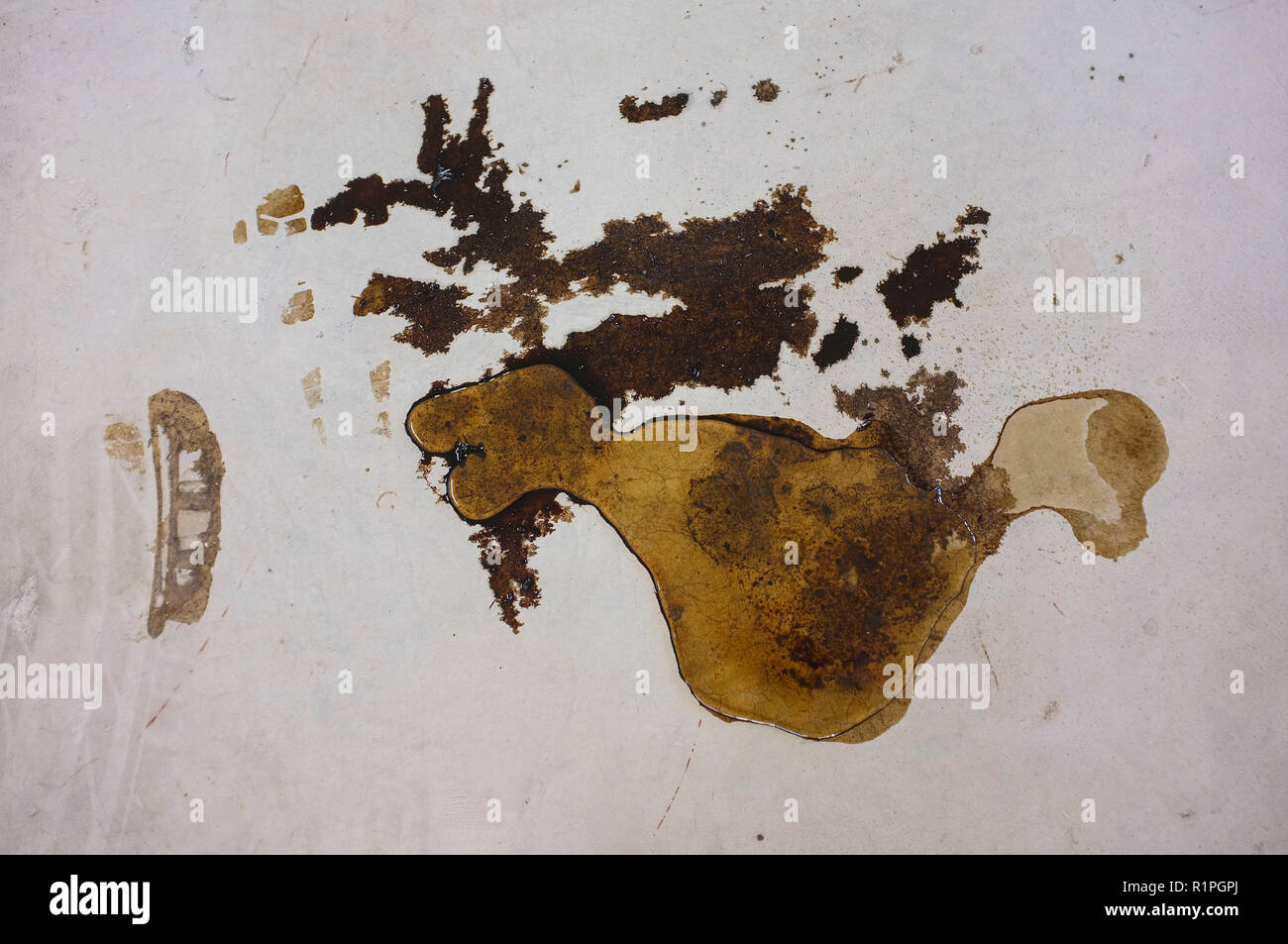Oil stain on the floor of a garage parking. Stock Photo