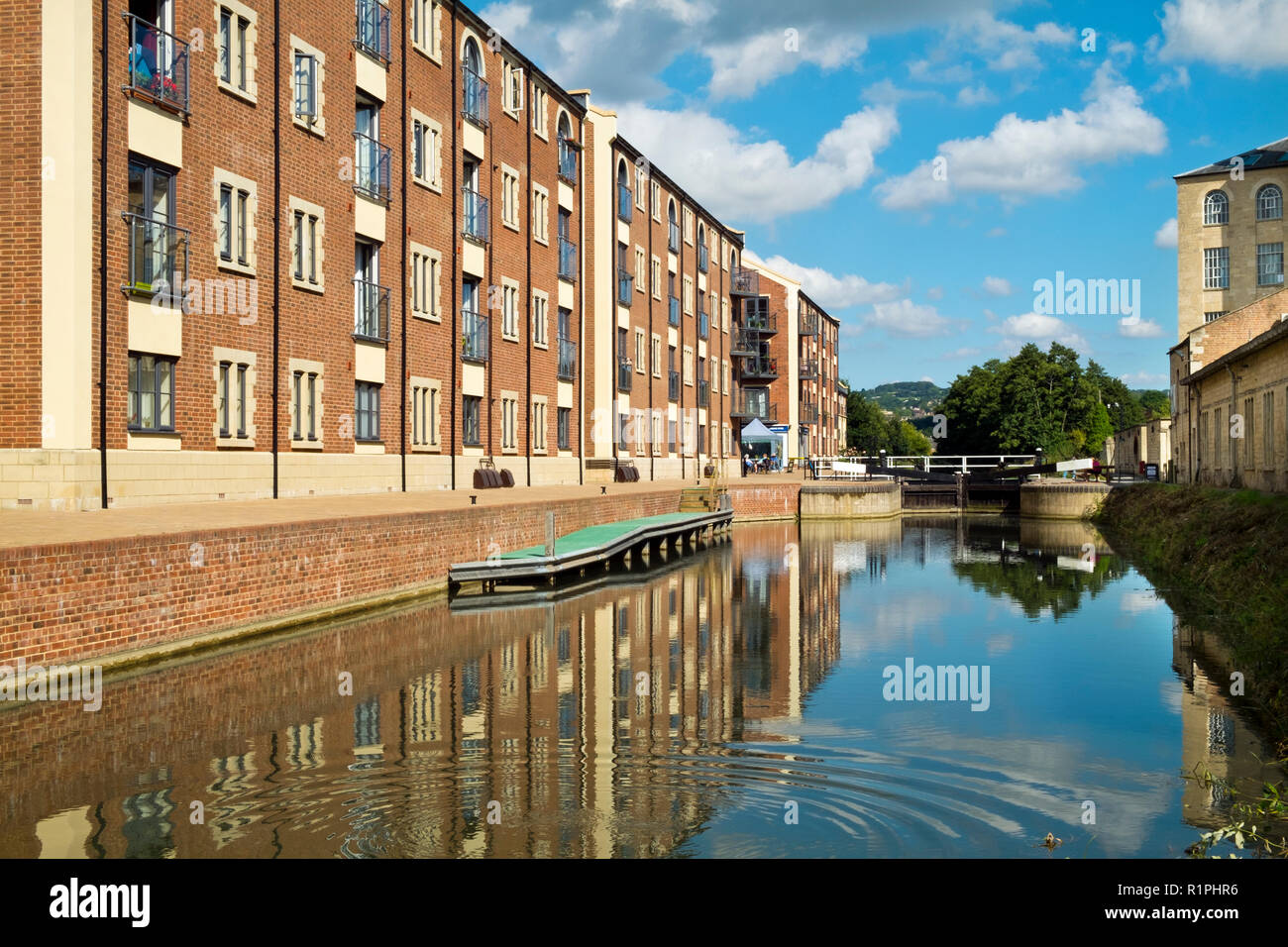 Stroud, Gloucestershire, UK - 26th August 2016: Summer sunshine brings people out to enjoy the regenerated Stroudwater Canal project at Ebley, Stroud, Gloucestershire, UK. Recently built apartment buildings enhance the waterside around historic Ebley Mill. Stock Photo