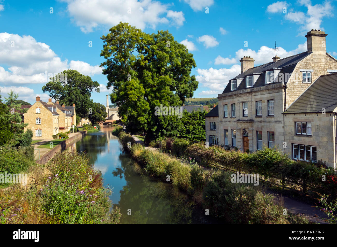 Stroud, Gloucestershire, UK - 26th August 2016: Summer sunshine brings people out to enjoy the regenerated Stroudwater Canal project at Ebley, Stroud, Gloucestershire, UK. Recently built housing enhances the waterside near historic Ebley Mill. Stock Photo